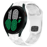 Football texture silicone watch band on Samsung Galaxy Watch 4 showing a digital display in vibrant colors.