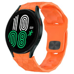 Football texture silicone watch band in vibrant orange color for Samsung Galaxy Watch 4 and Classic models.